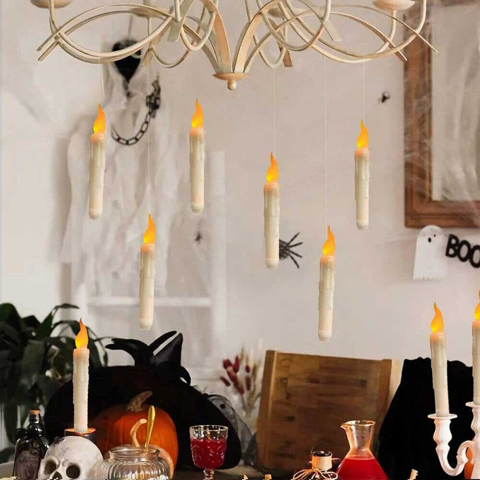 A set of 12 glowing LED floating taper candles suspended in the air with warm yellow flickering flames against a dark background.