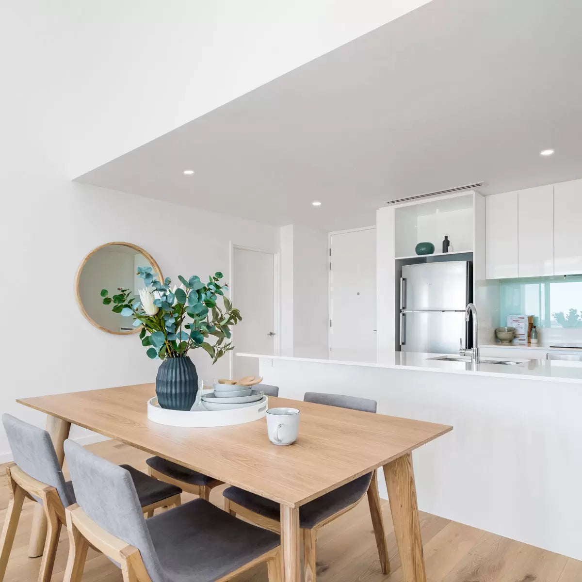 A minimalist matte white 4lite WiZ smart downlight recessed cleanly into a white ceiling, glowing with a soft, warm candle-like light.