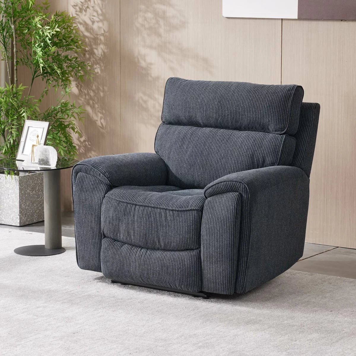Three-quarter view of the Atlanta grey cord fabric power recliner armchair in a bright living room setting, showcasing its striped textured fabric and sleek side