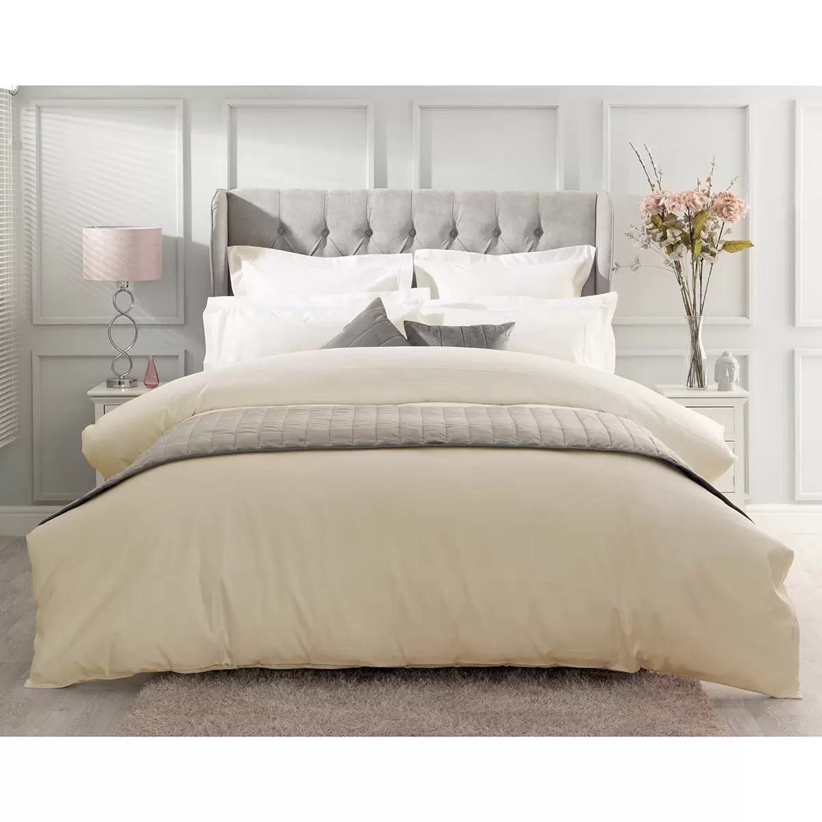 Ivory Belledorm 1000 thread count Egyptian cotton sateen duvet cover draped over a modern bed frame in a brightly lit bedroom.