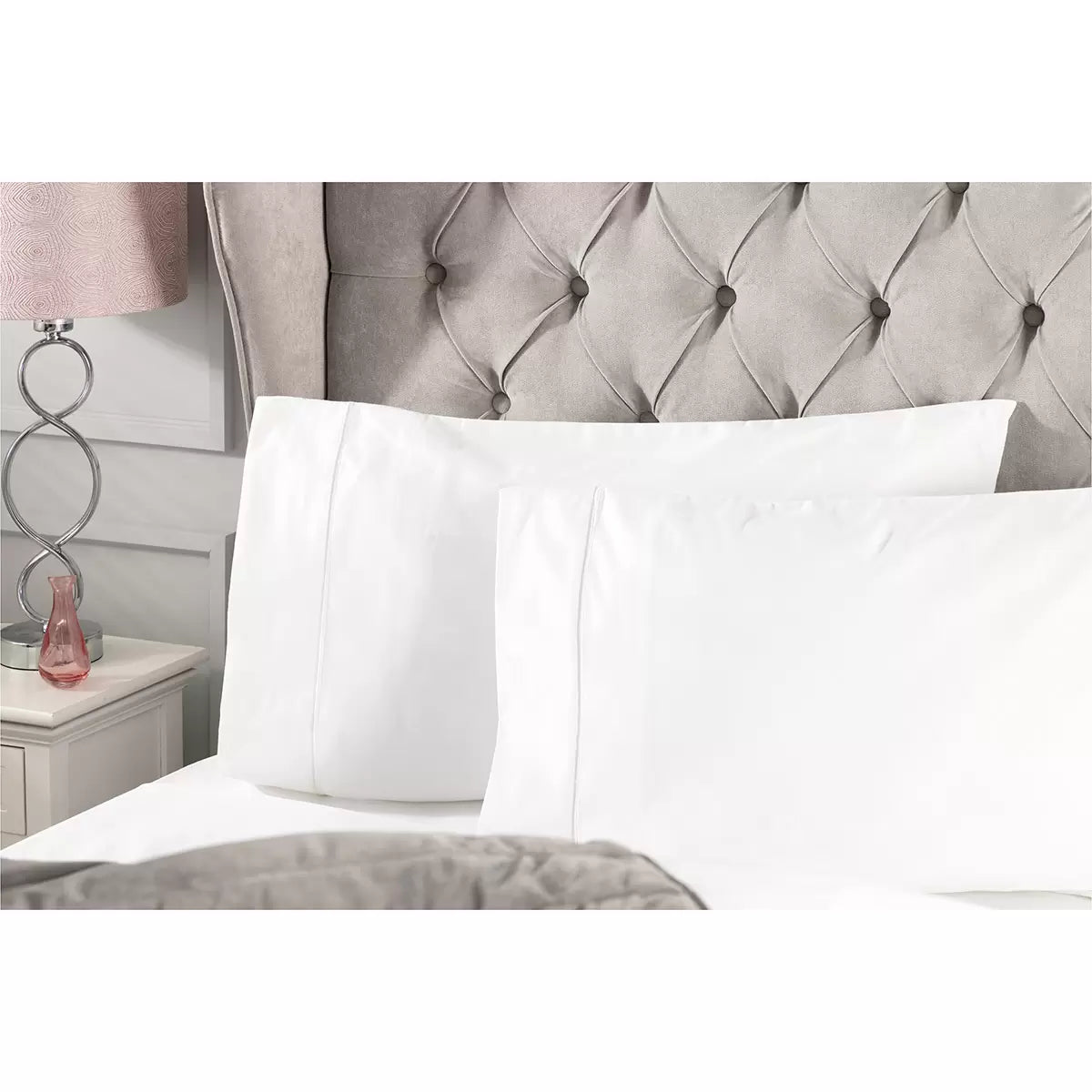 Angle view of the Belledorm 1000 thread count pure Egyptian cotton sateen bedding bundle in crisp white, showing the smooth, lustrous drape of the duvet cover and pillowcases on a made bed.