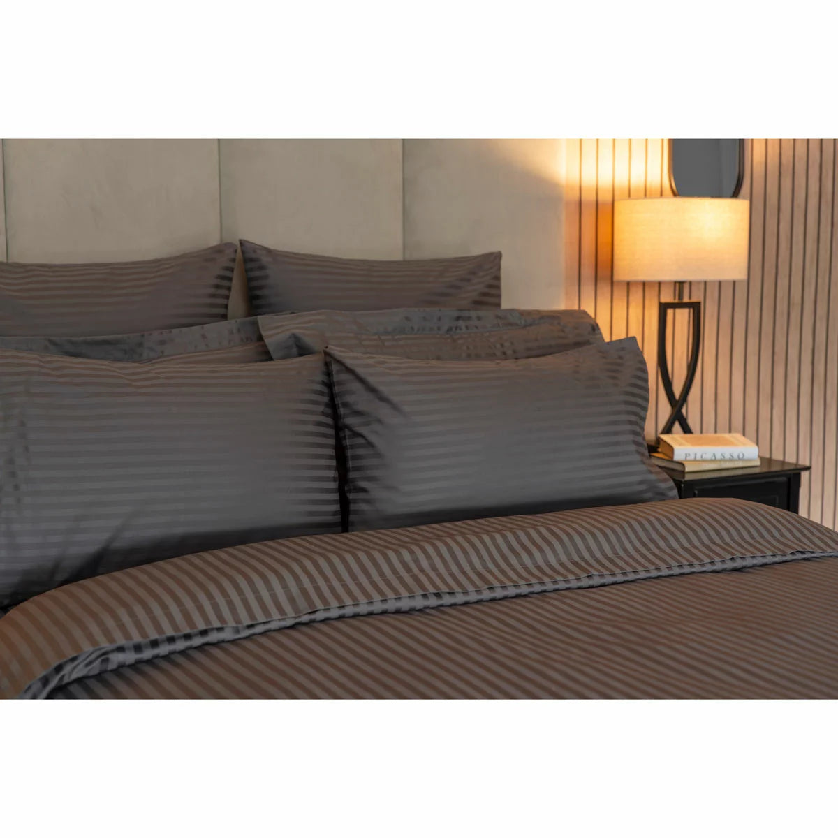 Flat lay of the Belledorm 540 thread count charcoal satin stripe double duvet cover set with matching pillowcases arranged neatly on a modern bed.