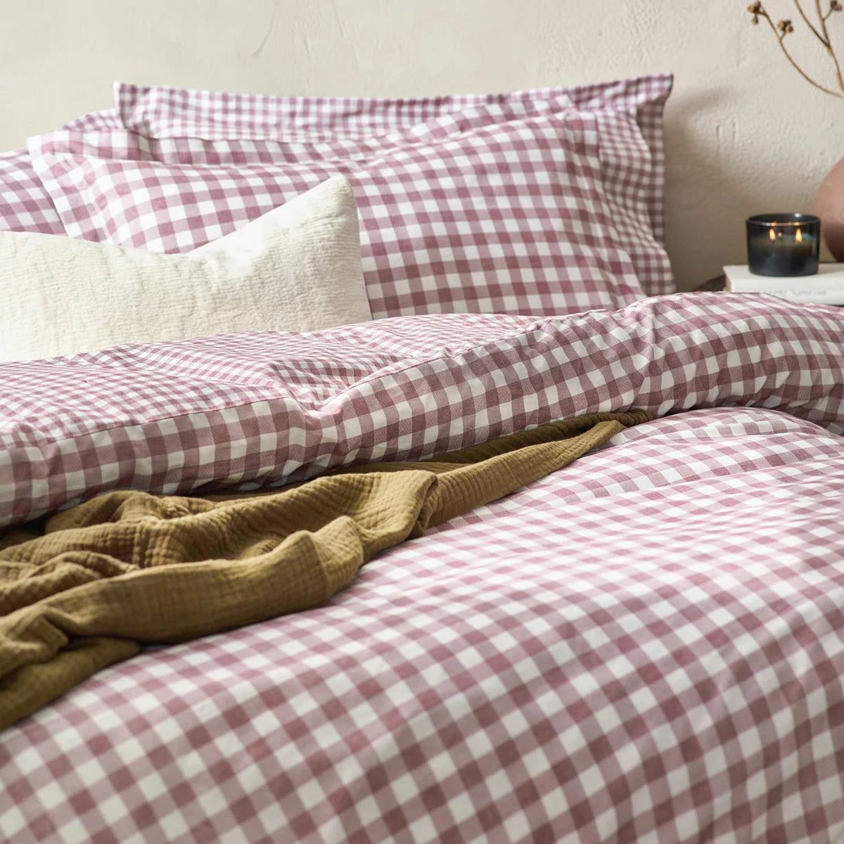 Flat lay of the single Yard Barton 100% cotton duvet cover set in berry gingham on a white wooden bed, showcasing the reversible mélange reverse pattern and neat Oxford border pillowcase.