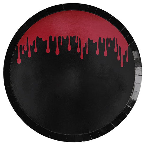 Flat-lay view of eight 25cm white paper plates covered in realistic red blood splatter art arranged on a dark Halloween party table.