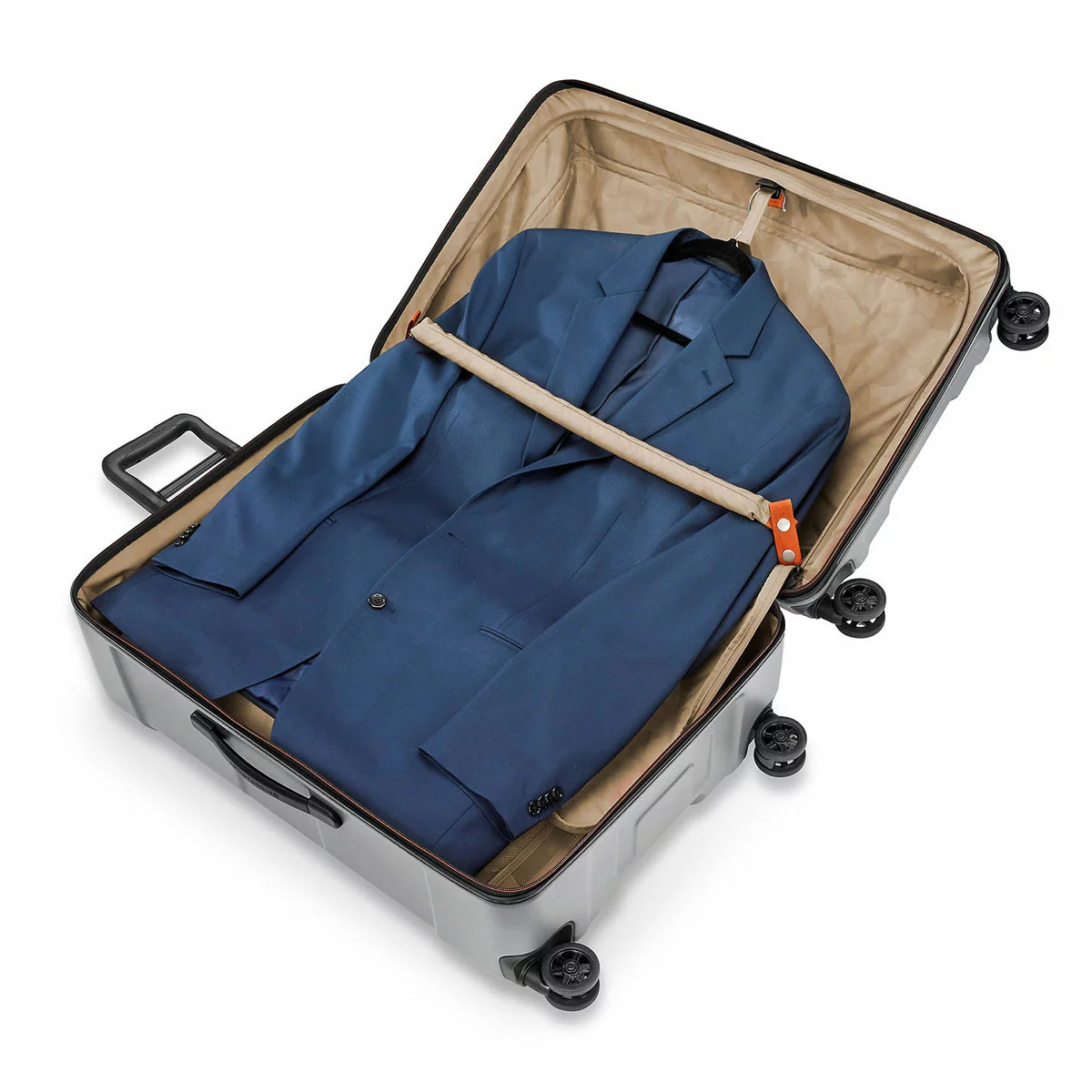 Textured dark metallic Briggs & Riley Torq 78cm Large Spinner Suitcase with molded handles and four dual ball-bearing spinner wheels standing upright on an airport terminal floor.
