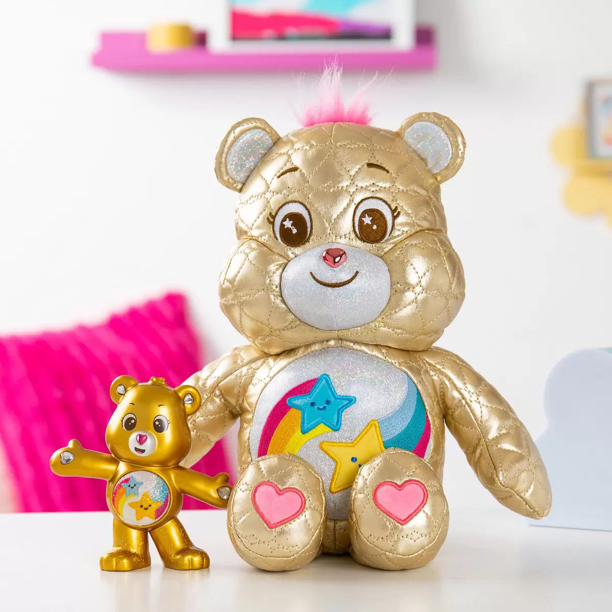 Front view of the 35cm limited edition gold Dare To Care Bear plush sitting upright against a neutral studio backdrop.