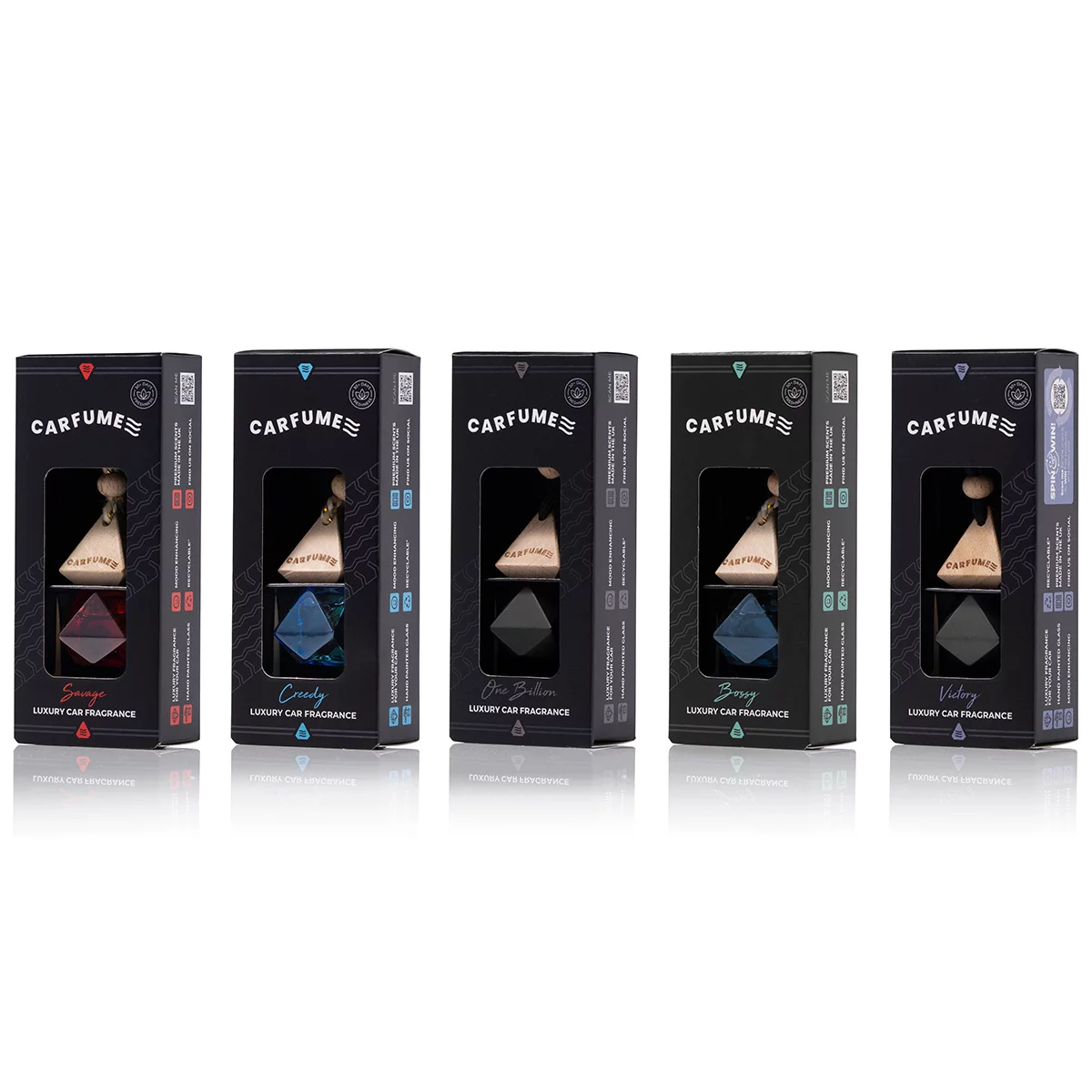 Five small square glass car diffusers with hanging cords and light-colored wooden caps, filled with golden fragrance oils, arranged in a row on a black background.