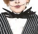 Front view of a child wearing the black and white pinstripe Jack Skeleton suit with bat bow tie against a dark background.