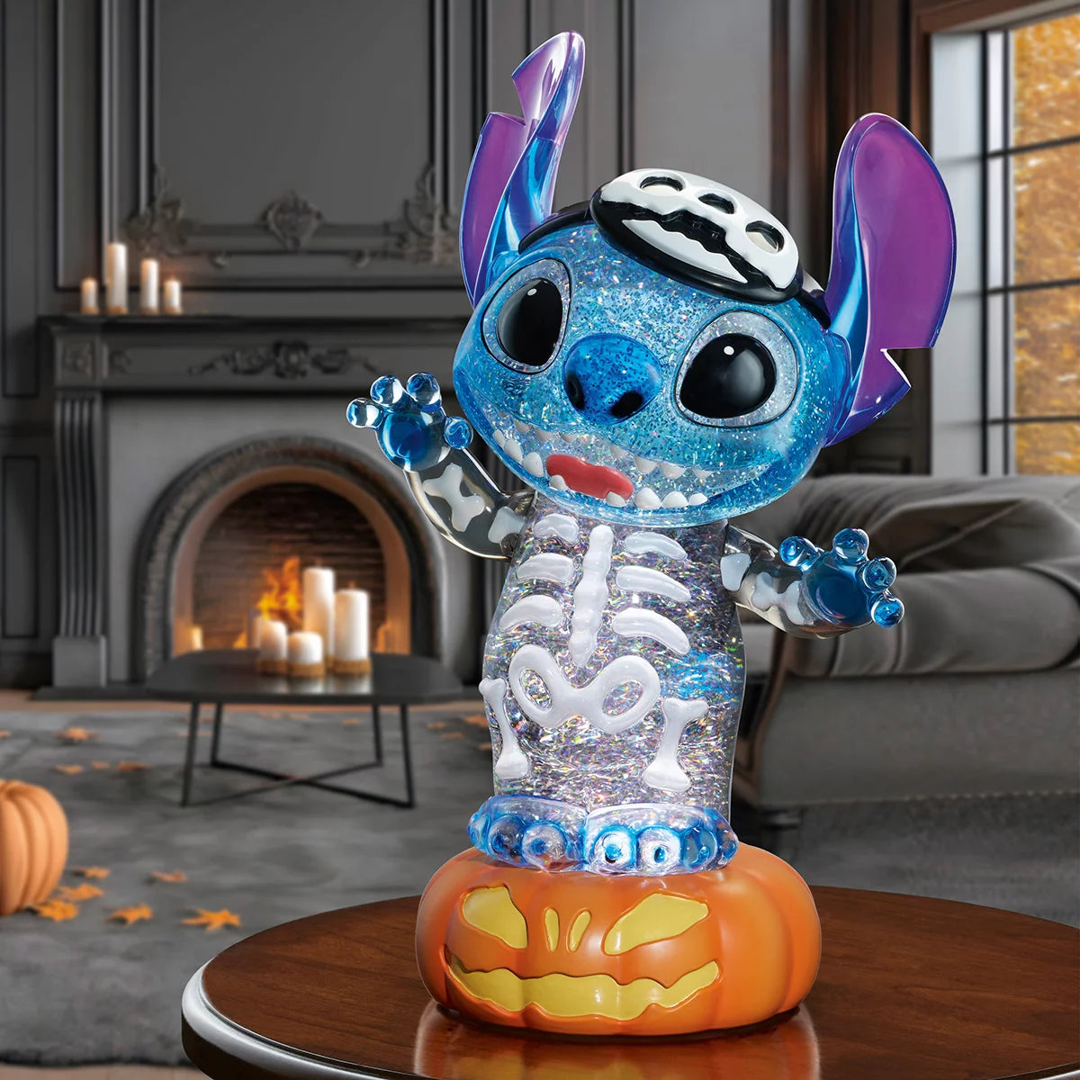 A 16-inch black Disney Halloween lantern displaying intricate character sculptures inside a liquid-filled chamber with glowing orange LED lights and swirling gold glitter sparkles, captured from a front eye-level perspective.