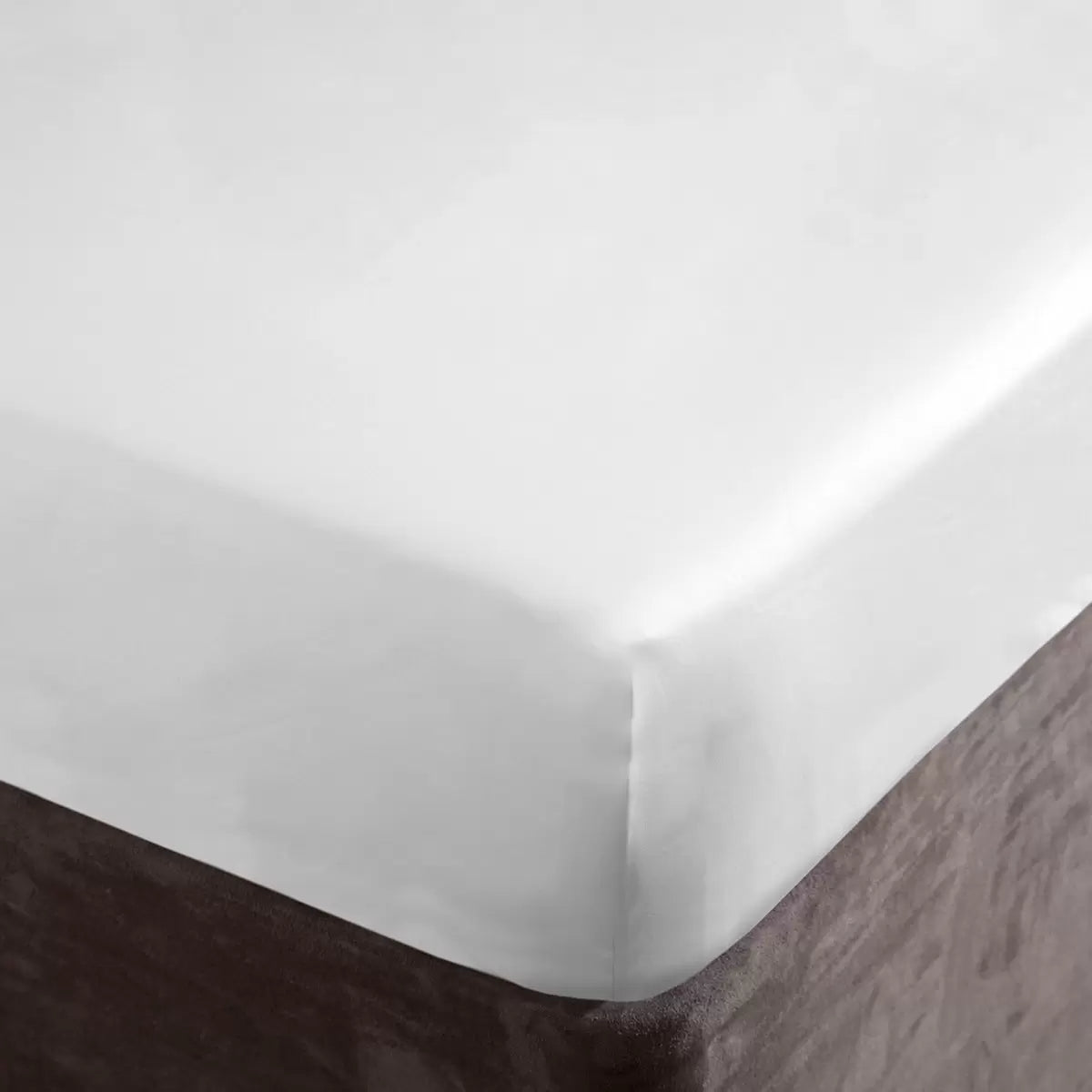 A close-up crisp studio shot of the white Belledorm 1000 thread count Egyptian cotton sateen sheet pulled tightly and smoothly over the deep corner of a mattress.