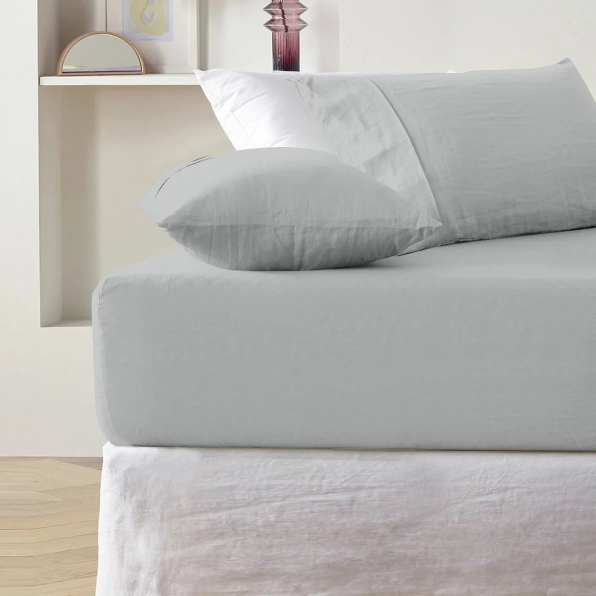 A close-up overhead shot of a neatly tucked Purity Home charcoal grey 400 thread count cotton fitted sheet stretched tightly over a deep mattress corner.
