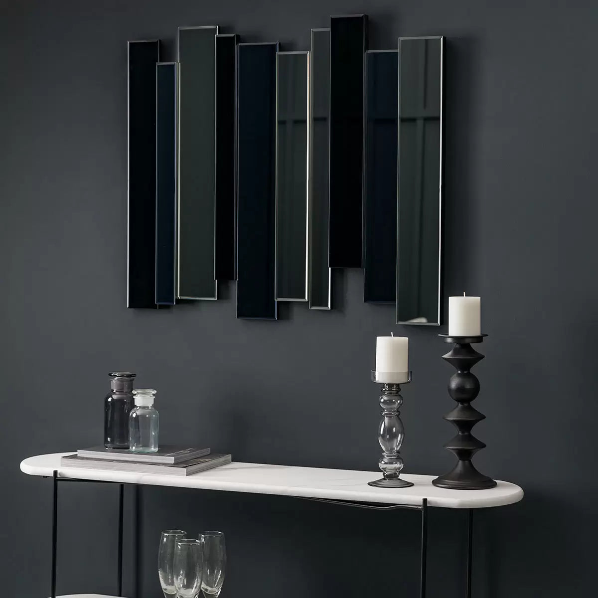 Gallery Duval Art Deco grey smoked mirror with layered multi-tinted clear and black glass panels mounted vertically on a neutral hallway wall.