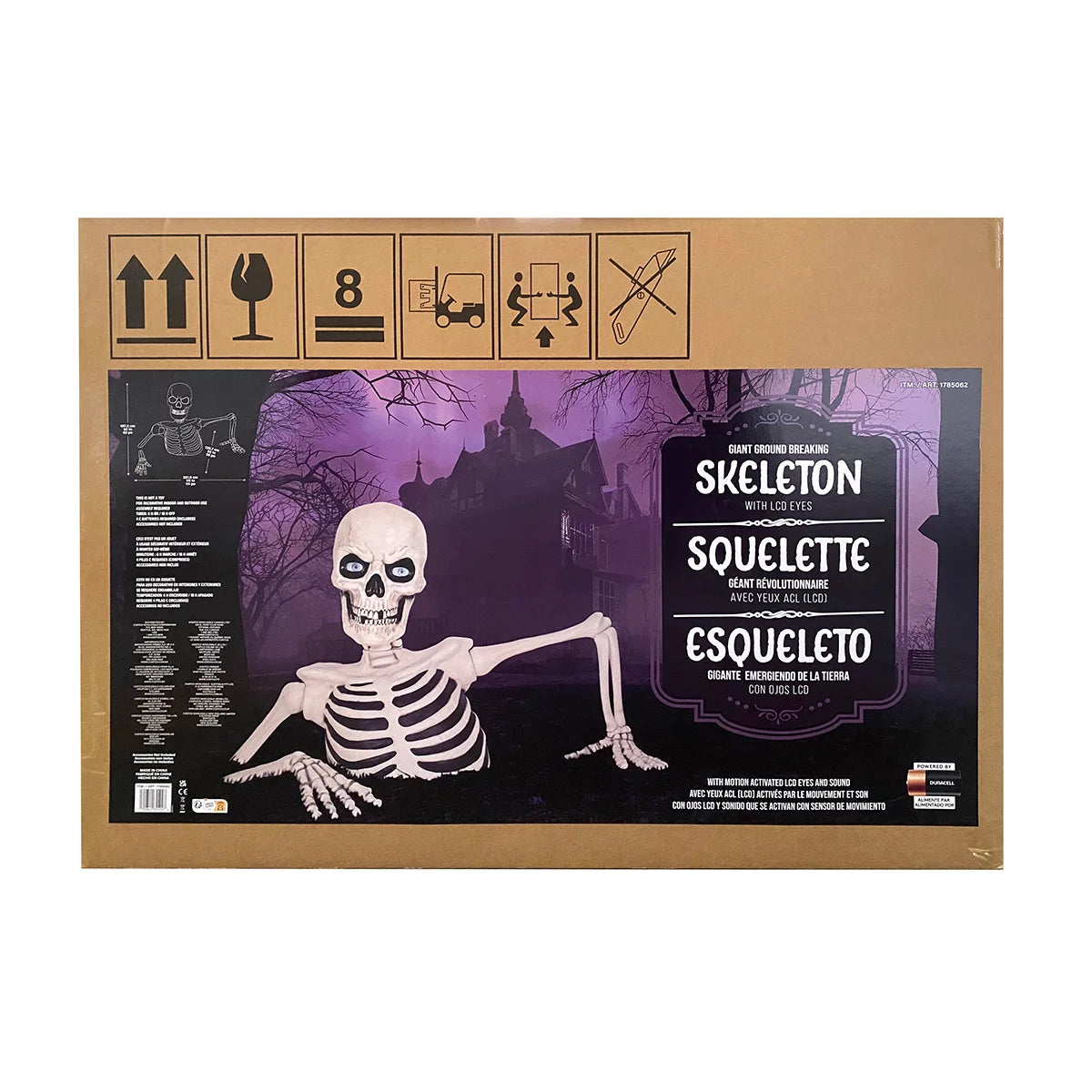 A massive 5-foot gray and bone-white ground breaking skeleton prop with glowing red LCD eyes appearing to burst out from green lawn grass at night.