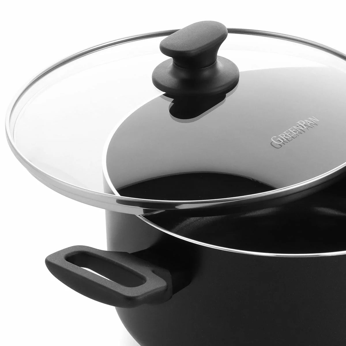 A complete 9-piece GreenPan Essence cookware set in a sleek black finish, arranged neatly on a modern marble kitchen countertop.