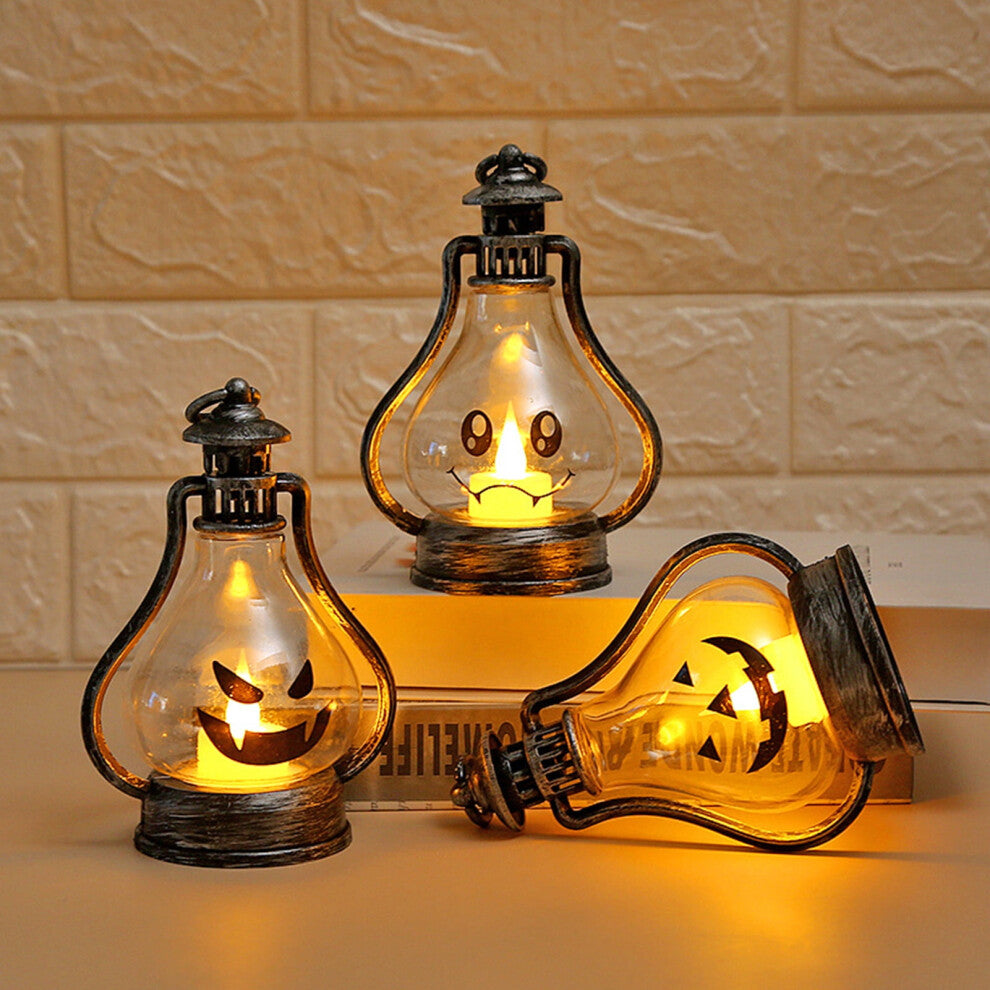 A high-brightness Halloween LED smiley face lantern hanging by its hook and glowing softly on a decorated tabletop.