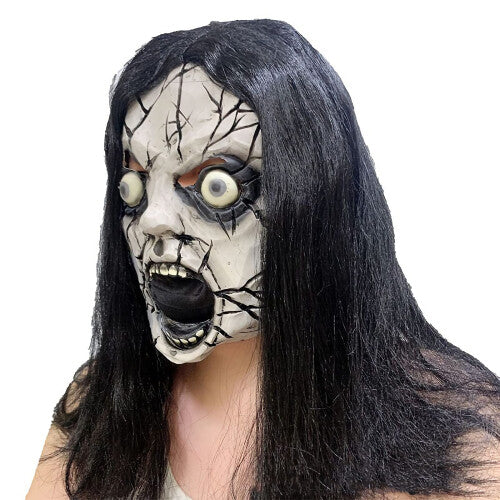 Textured gory Halloween zombie mask made of detailed latex with painted blood details on an adult model against a dark backdrop.