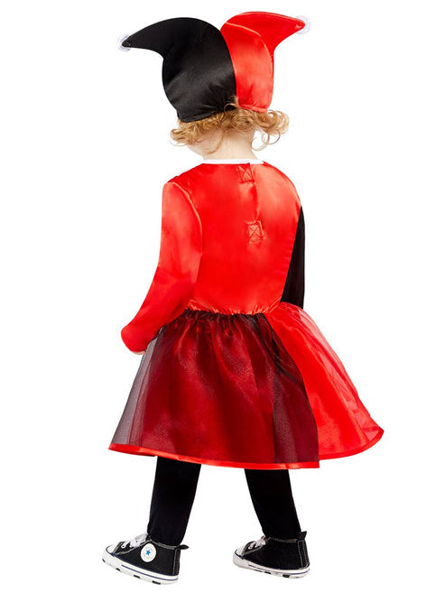 Front view of a toddler wearing a red and black Harley Quinn costume dress with diamond prints in a brightly lit play area.
