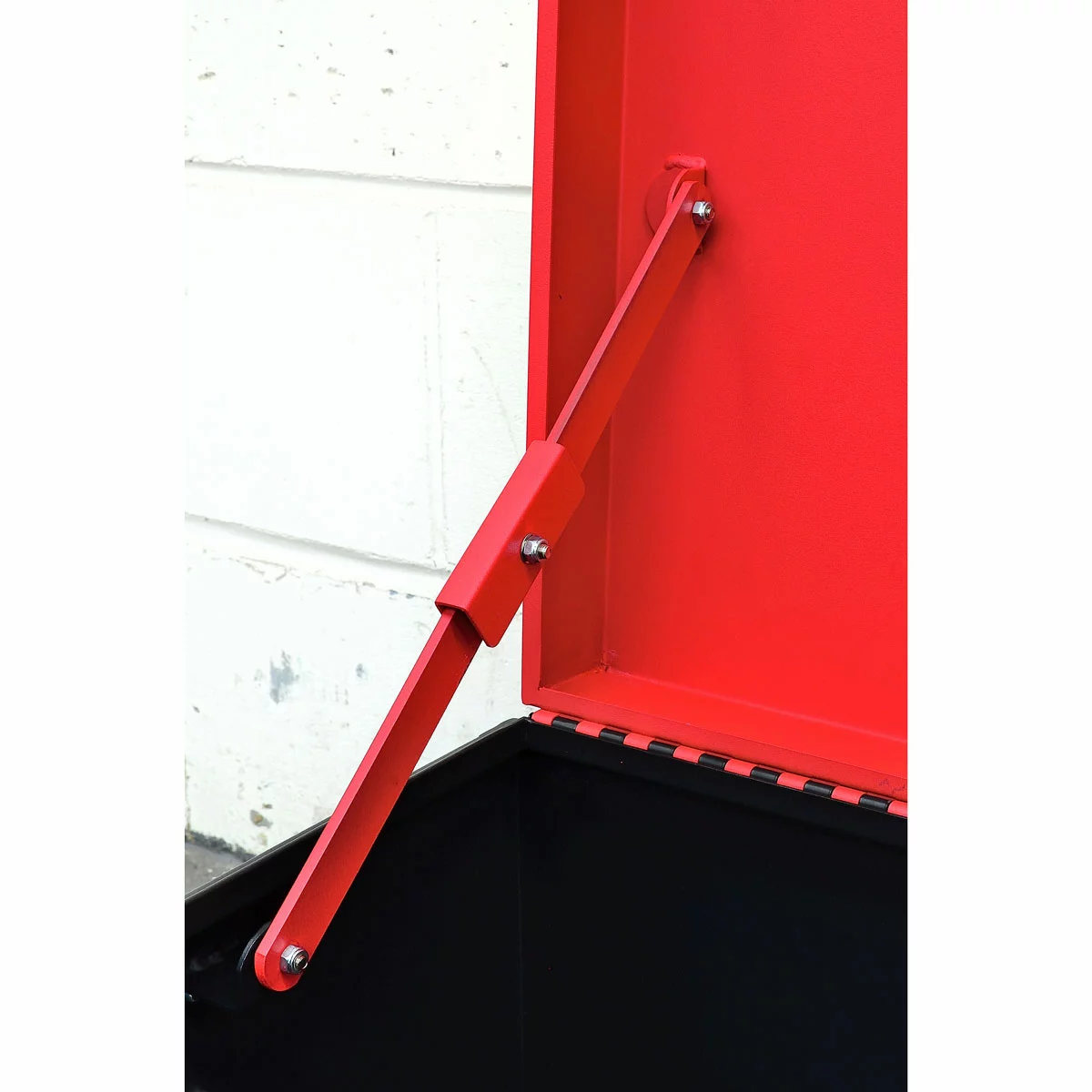 Industrial matte-finish grey steel Hilka 32-inch heavy duty van storage box showing its recessed locking ports and reinforced piano-hinge lid in the back of a professional transit work vehicle.