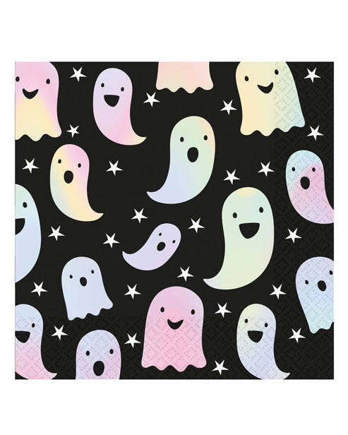 Opened pack of square white 33cm paper napkins featuring printed holographic ghost patterns laid out on a dark grey wooden party table.