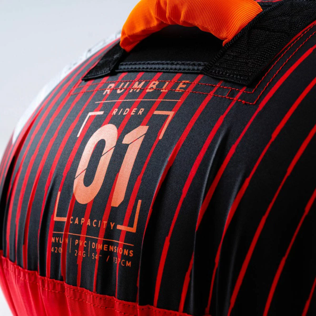 Bright red Jobe Rumble 1 Person Inflatable Towable resting on a boat deck with visible neoprene handles and quick tow connector.