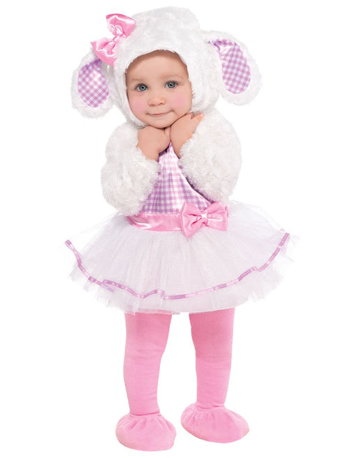 Front view of a toddler wearing the plush white Little Lamb costume hood with pink-inner ears on a cozy hardwood floor setting.