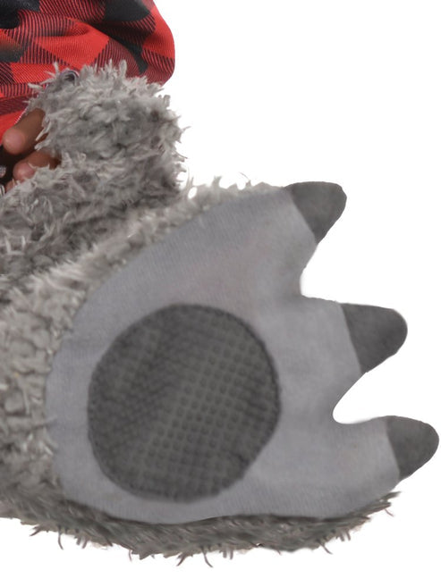 Front view of an infant wearing a fluffy grey wolf costume jumpsuit with an attached red plaid shirt, plush wolf ear hood, and matching grey booties against a neutral backdrop.