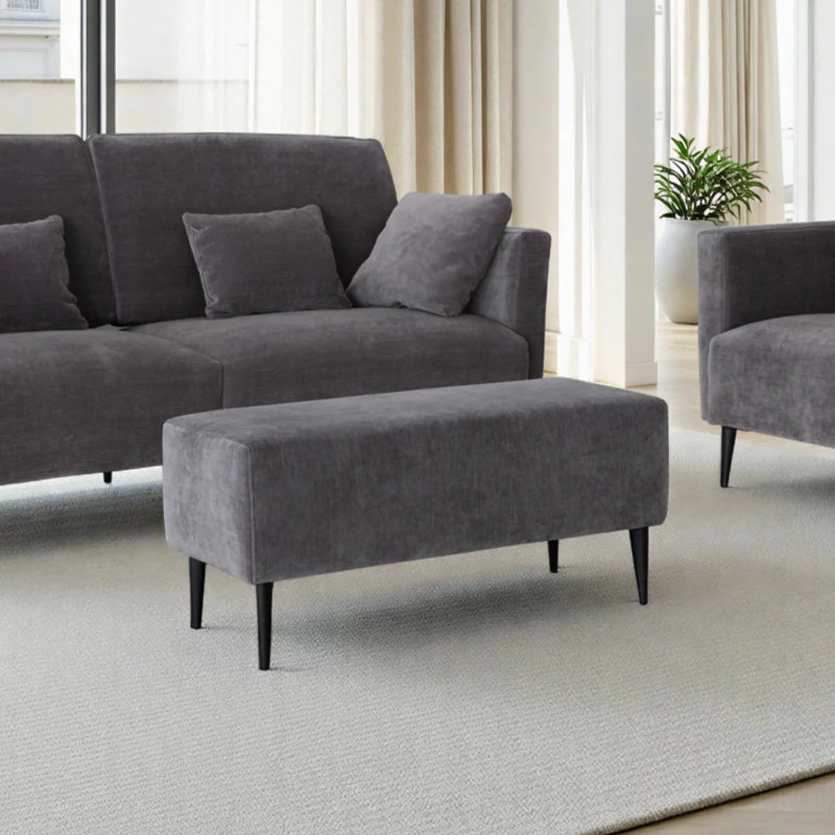 MOONAP Monroe Dark Grey Fabric Footstool with cushioned upholstered top in a contemporary living room setting