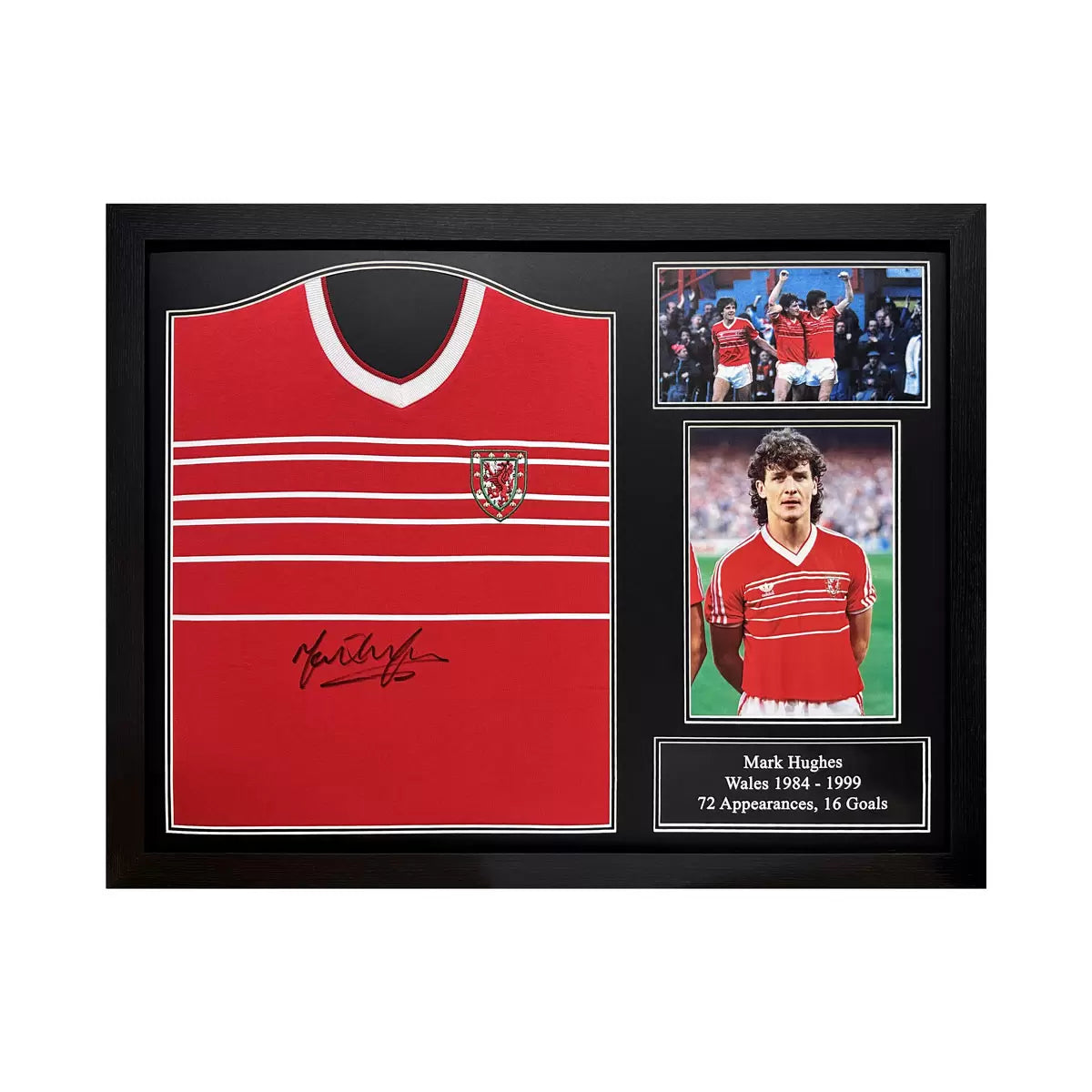 A professionally framed retro 1984 Wales football shirt hand-signed by Mark Hughes, displayed in a dark-wood frame against a clean wall.