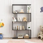 Black wood S-shaped four-tier modern bookcase loaded with books and decorative vases against a neutral living room wall.