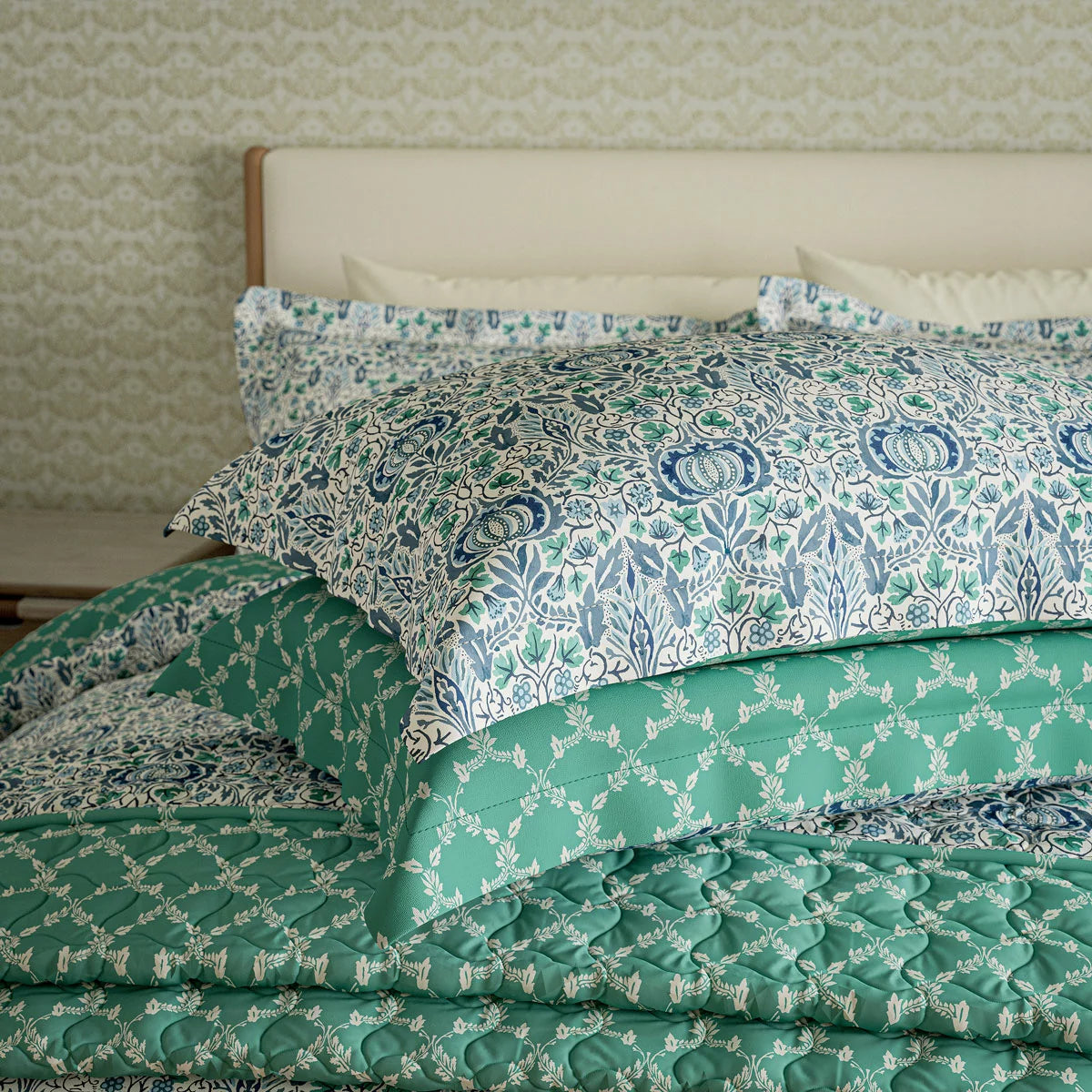 Front view of the Morris and Co Little Chintz cotton duvet cover set displaying the detailed pomegranate pattern on a neatly made bed in a brightly lit bedroom.