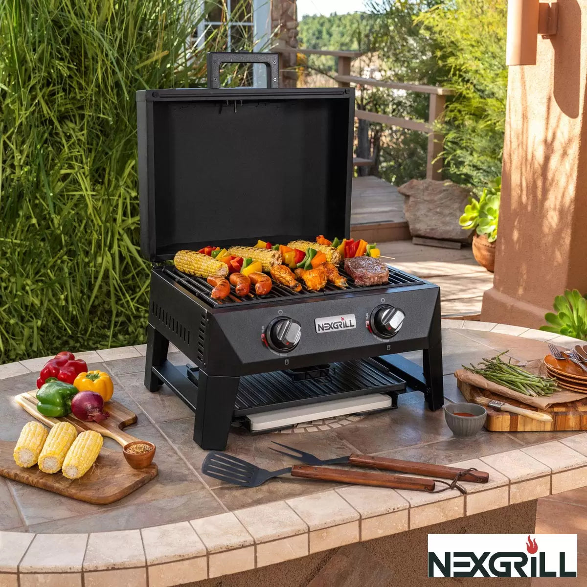 Stainless steel Nexgrill Fortress 2 Burner 4-in-1 grill configured as a pizza oven on a modern patio.