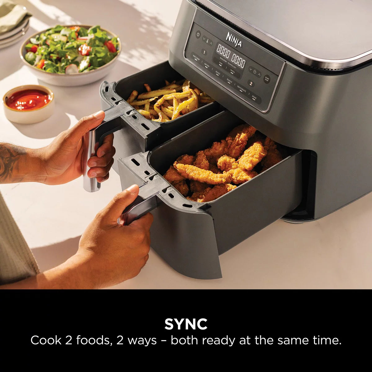 Front view of the Ninja DZ300UK Dual Zone Air Fryer in gun metal grey with both drawers closed sitting on a modern kitchen countertop.