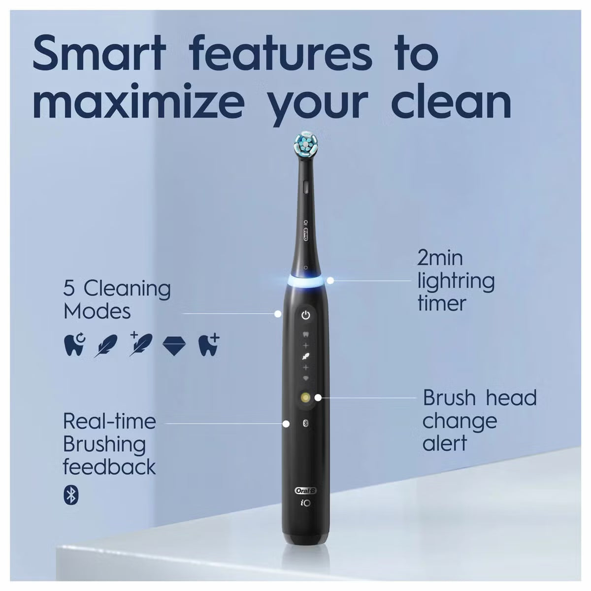 Oral-B iO Series 5 electric toothbrushes in Matt Black and Quite White standing upright with ultimate clean brush heads on a modern bathroom counter.