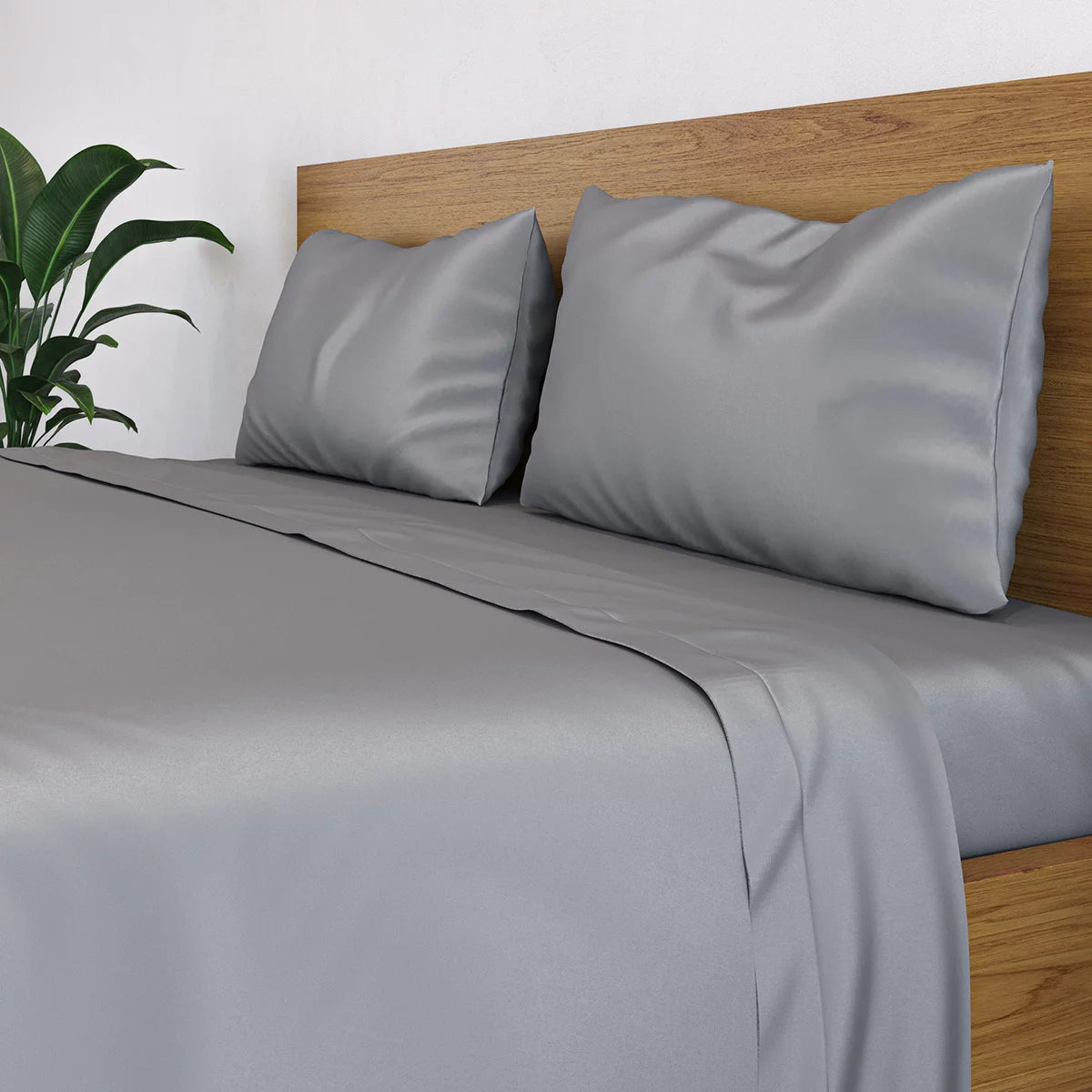 Neat fold of a charcoal grey Panda 100 percent bamboo flat sheet showing its silky sateen finish against a clean white mattress background.