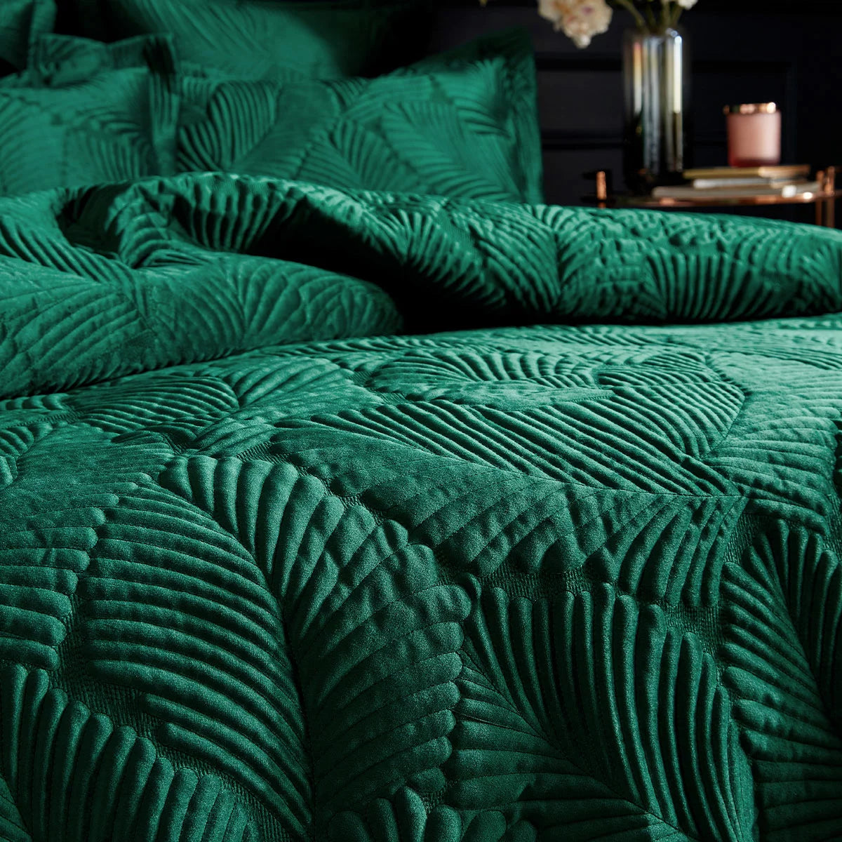 Rich emerald green Paoletti velvet duvet cover with detailed palm embroidery and matching Oxford pillowcases set on a bed.