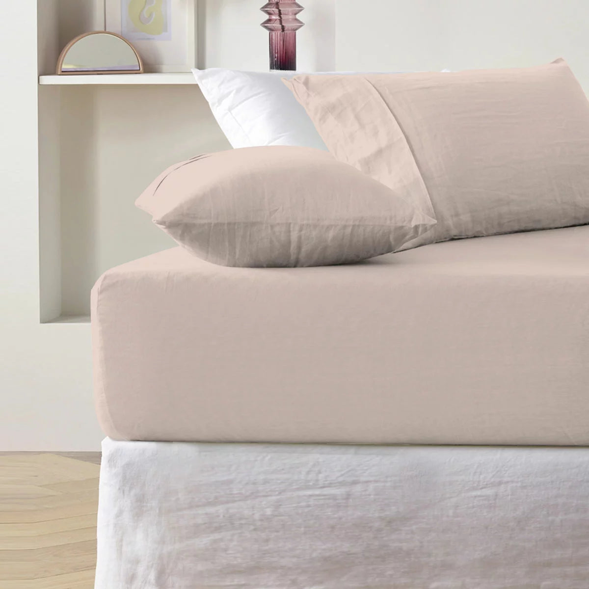 A single pink cotton sateen fitted sheet tightly secured over a thick mattress corner, demonstrating the snug fit of the True Grip elasticated base.