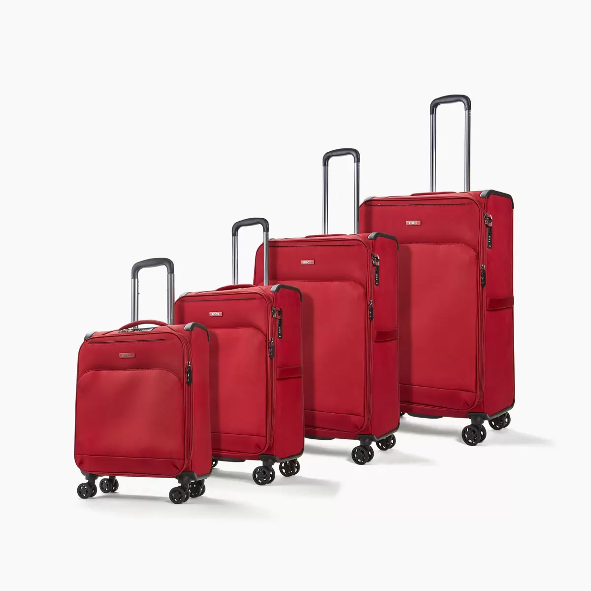 Nesting group shot of the Rock Georgia 4 Piece Softside Luggage Set displayed in three available colors, showing cabin, medium, large, and XL sizes with visible TSA locks and spinner wheels.