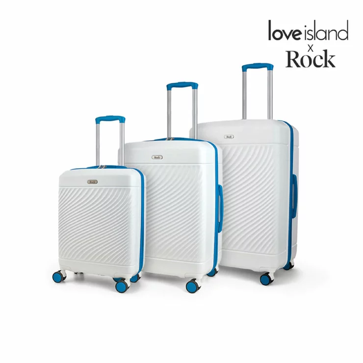 Front view of the Rock Love Island 3 piece hardside luggage set in glossy candy pink showing cabin, medium, and large suitcases lined up in a bright hotel lobby.