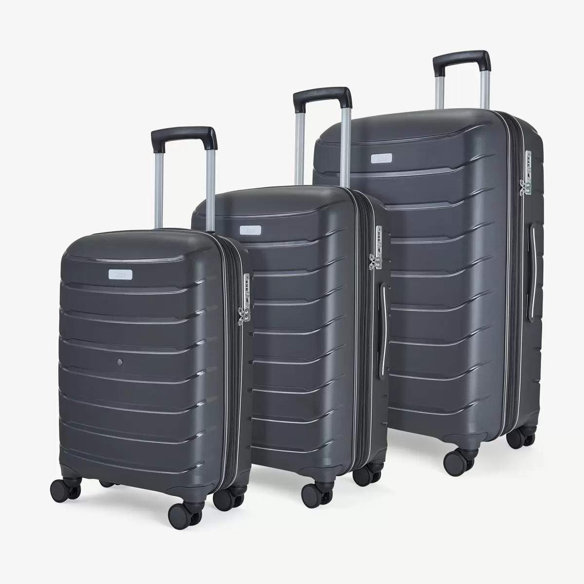 Front three-quarter view of the Rock Prime 3 piece hardside luggage set in charcoal grey showing textured shell lines and spinner wheels.