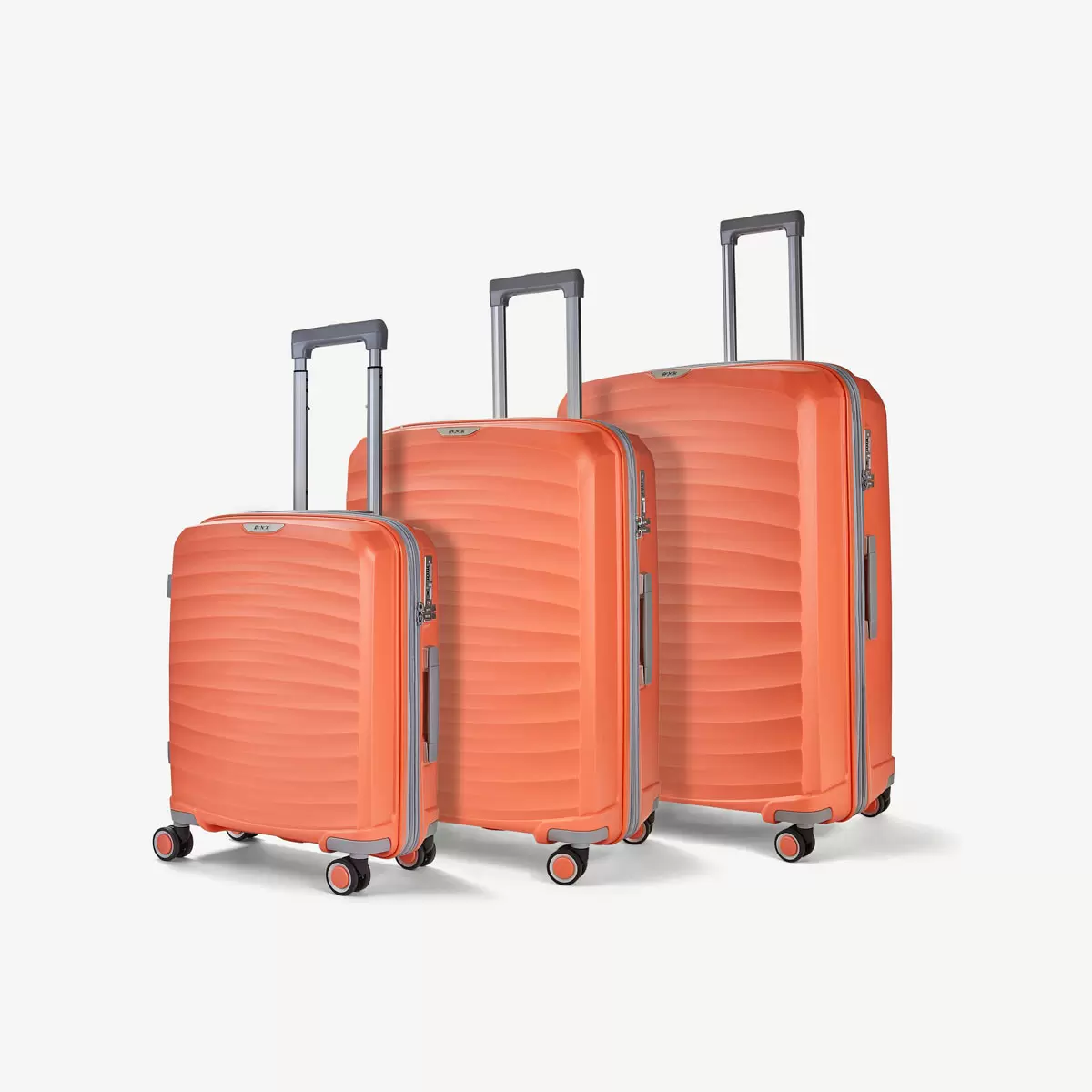 Three-quarter angle of three ocean-blue Rock Sunwave hardside suitcases stacked in cabin, medium, and large sizes on a glossy terminal floor.