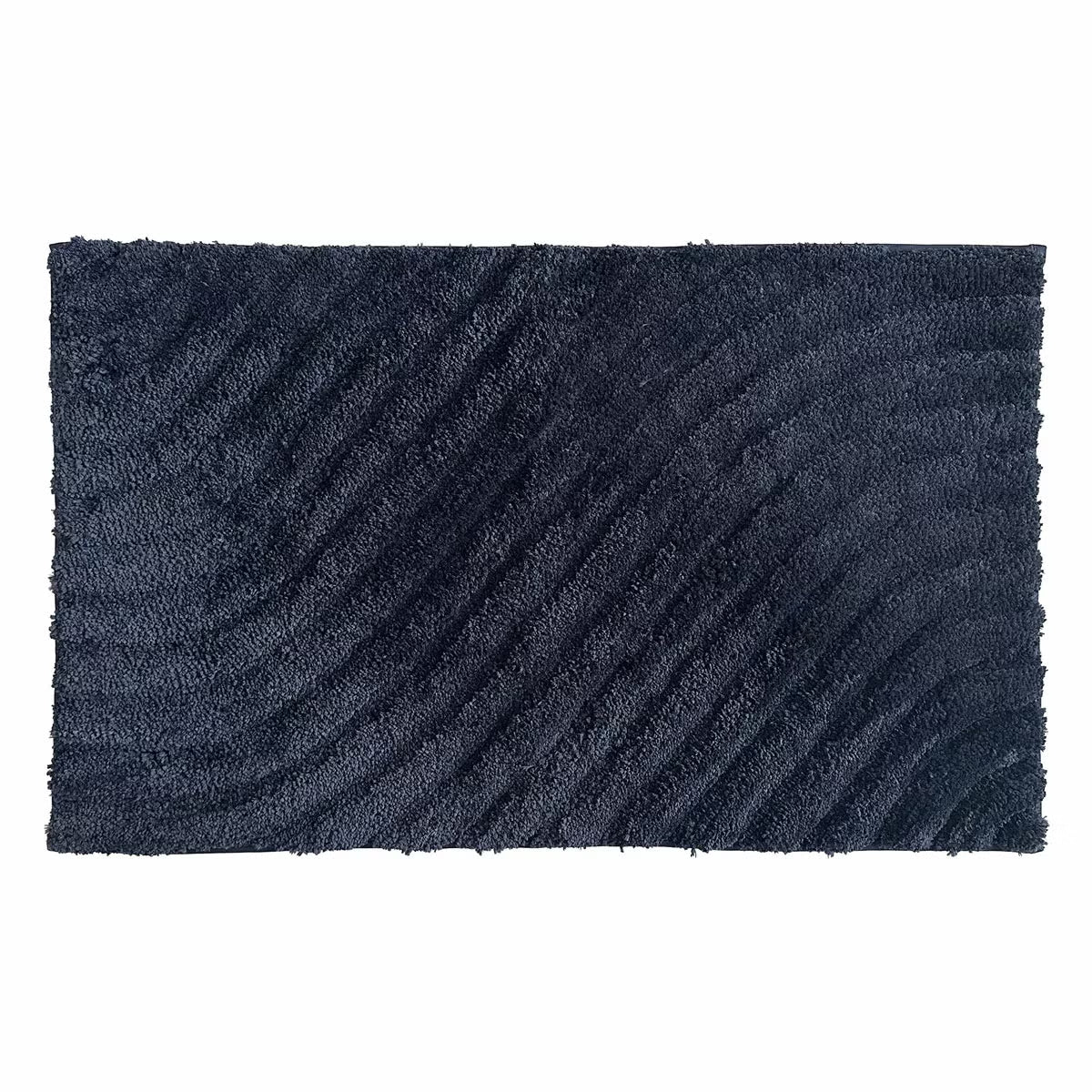 Overhead angled view of the plush grey Safdie Tufted Wave Bath Mat showing its sculpted high-low wave pattern on a light tiled bathroom floor.