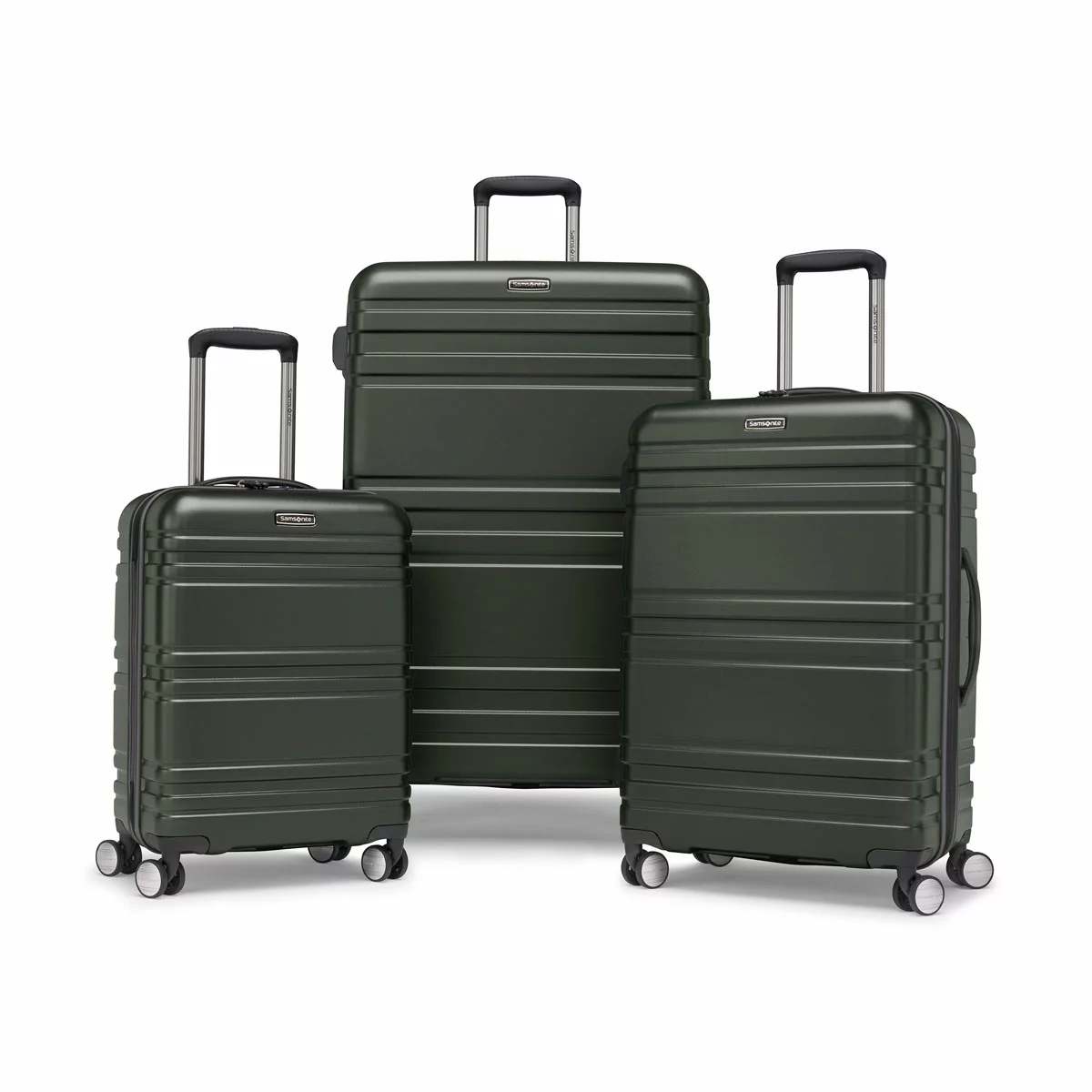 Samsonite Parallax 3 piece hardside luggage set stacked together in polished navy and grey finishes on a minimalist airport terminal floor.