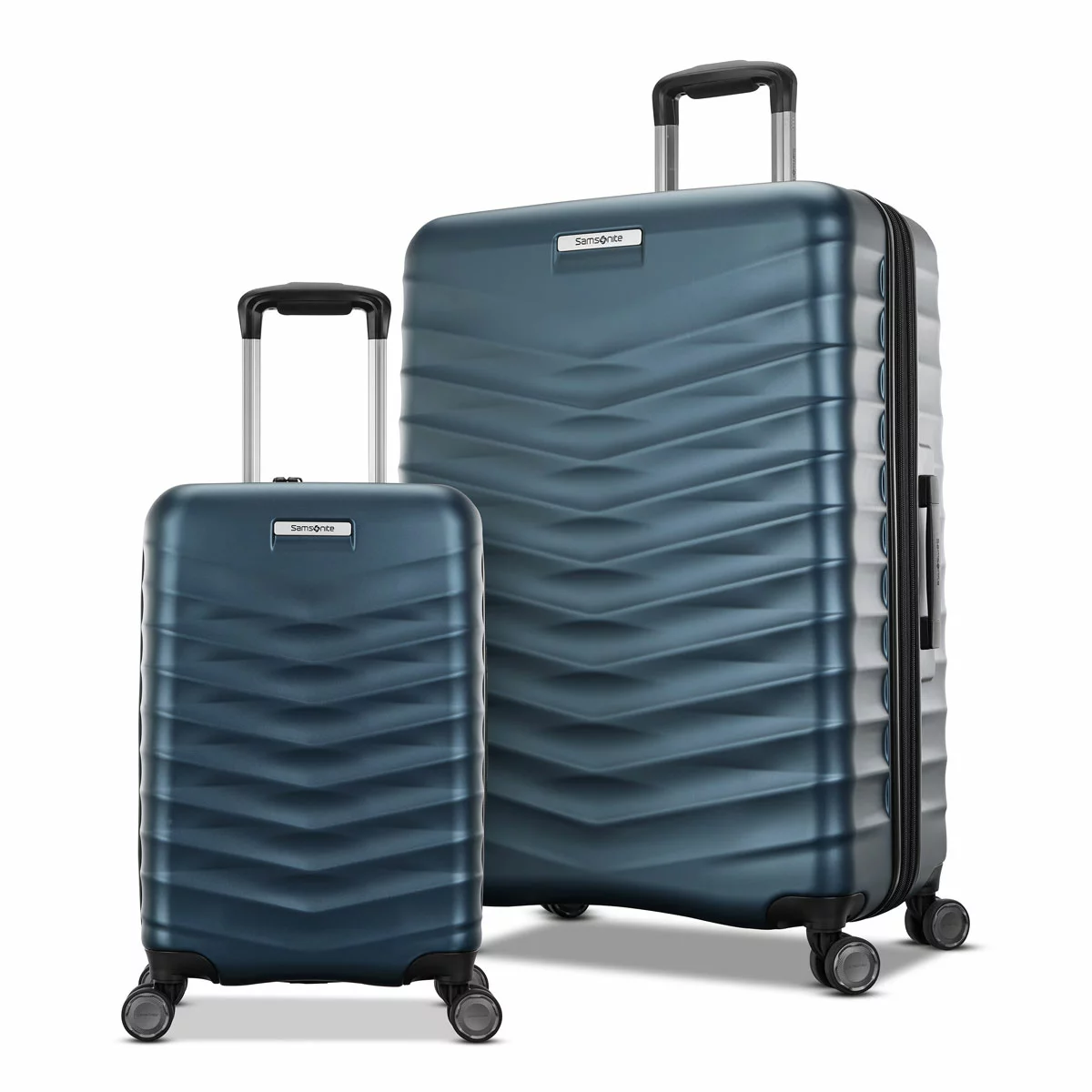 Front angle view of two Samsonite Precision DLX hardside spinner luggage pieces in slate grey standing upright on a sleek terminal floor.