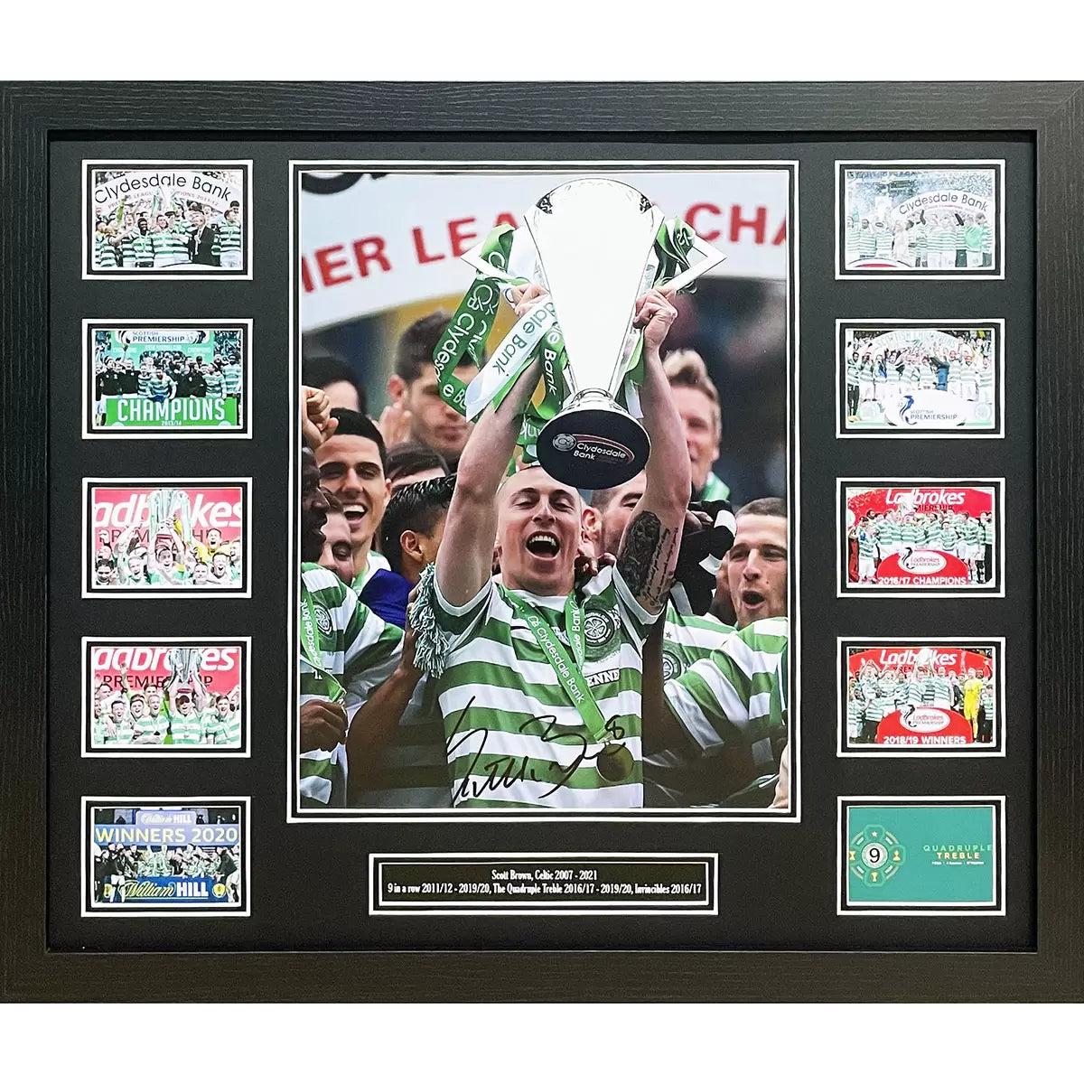 A high-quality, professionally framed action photograph of Celtic FC captain Scott Brown, featuring a clear hand-signature, displayed against a dark interior wall.