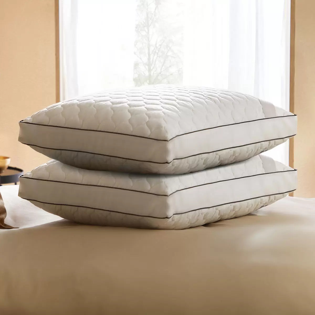 Pair of white Sealy Side Sleeper Pillows featuring a cushioned cotton finish arranged neatly on a bed.
