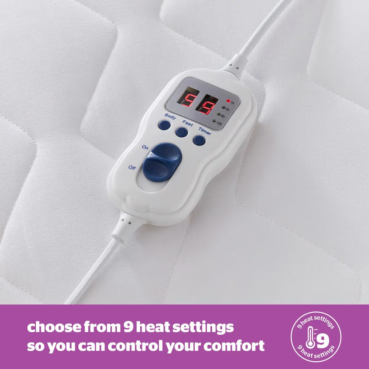 Close-up angled shot of the white Silentnight Deep Sleep Superking Heated Quilted Topper fitted over a mattress with its dual hand controller visible on a bedside table.