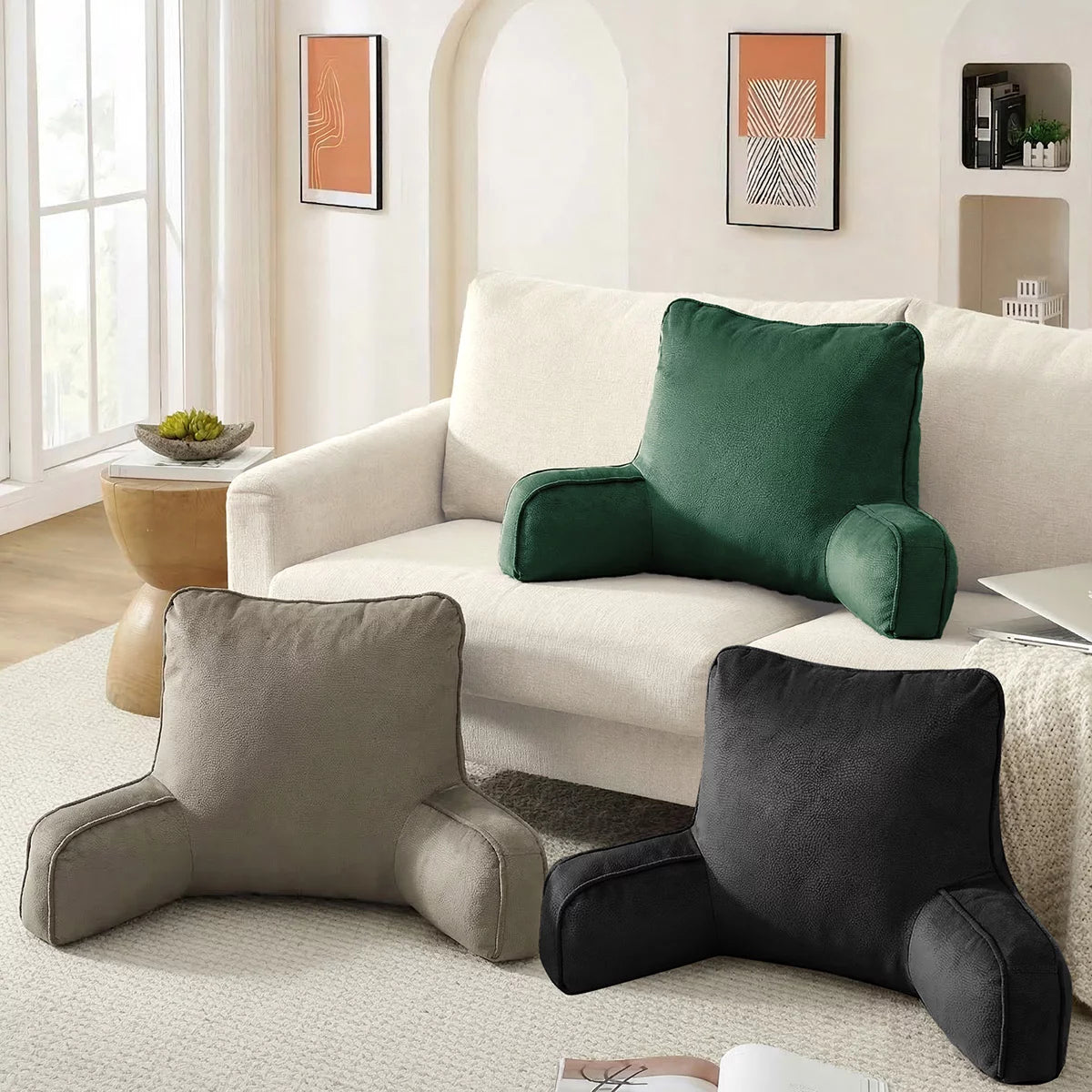 Textured faux suede backrest pillow with padded arms resting upright on a neatly made bed.