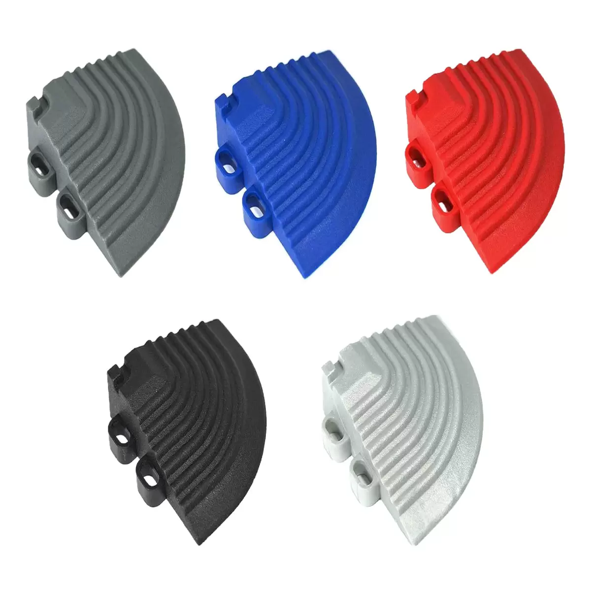 Angle view of four Swisstrax Ribtrax Pro vented modular corner ramps in black connected to a raised garage floor pad on a clean concrete floor.