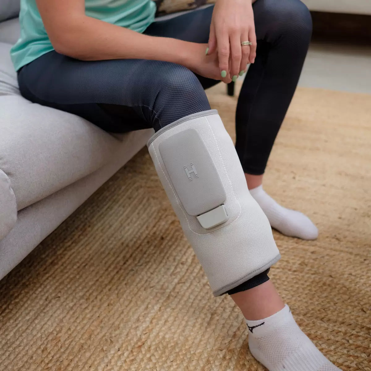 The Homedics Modulair compression bundle, featuring wireless controllers attached to calf and knee sleeves, presented in a clean, modern aesthetic.