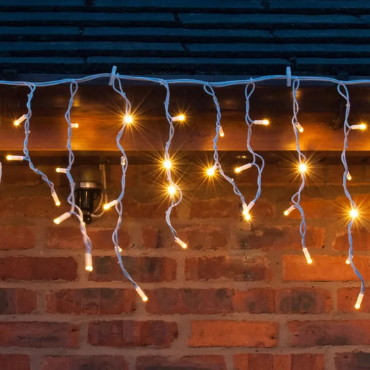 Lights4You warm white LED icicle lights hanging along a roofline